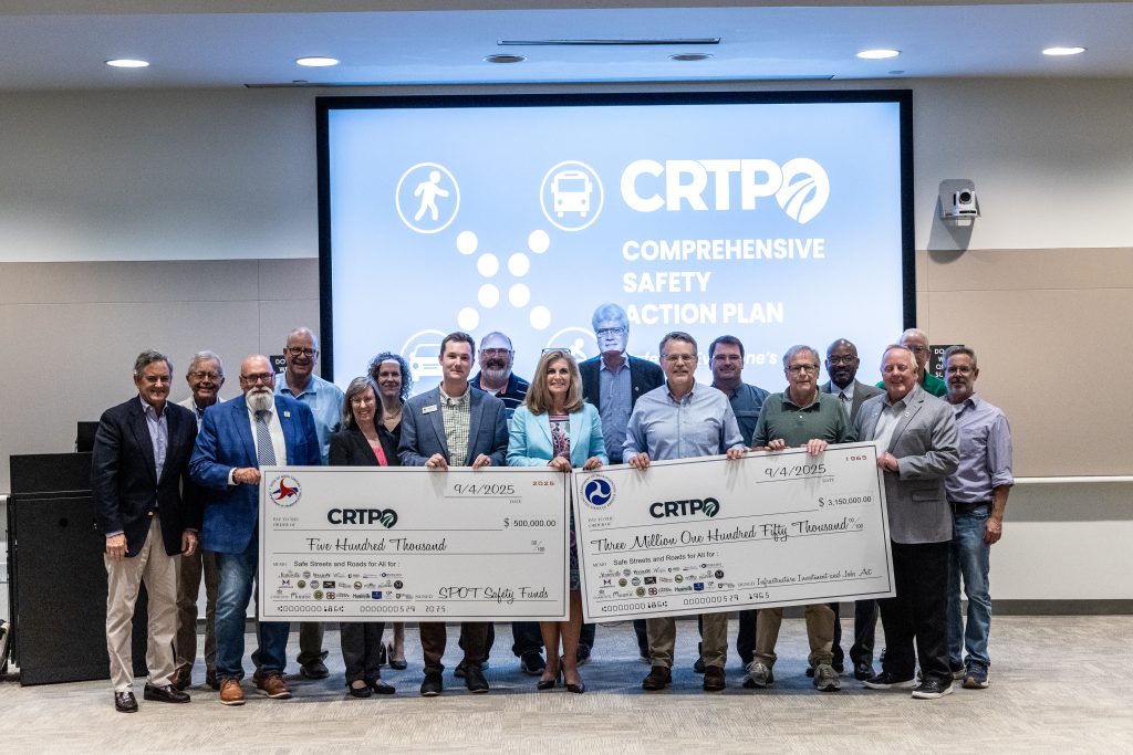CRTPO staff and board members holding a large federal funding award check